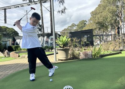 A child playing golf.