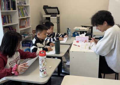 Kids in class with a teacher.