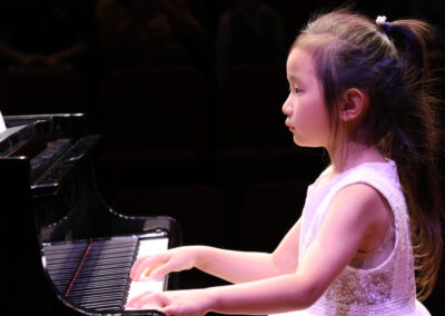 A girl playing a piano.