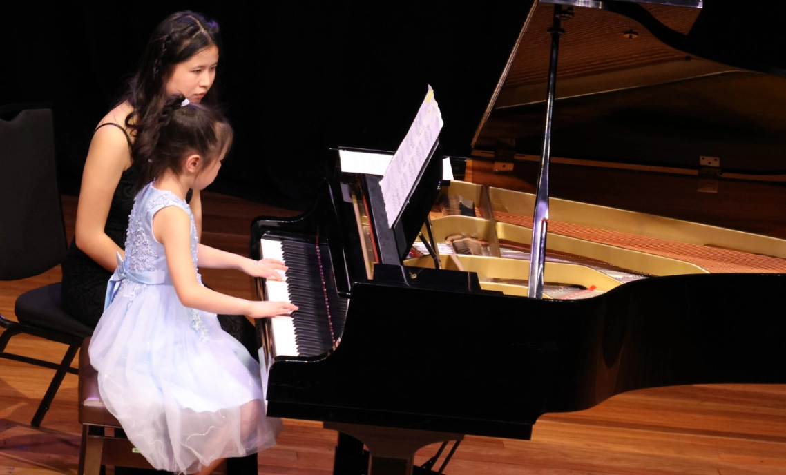 A girl playing a piano.